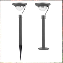 Load image into Gallery viewer, Hidalgo solar bollard light illuminated at night, warm LED glow along garden path