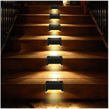 Load image into Gallery viewer, Solar LED path lights illuminated at night, warm white glow along garden walkway