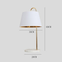 Load image into Gallery viewer, Malambo floor lamp black shade variant illuminated, warm light through fabric
