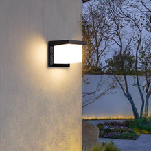 Load image into Gallery viewer, Manzanillo box wall light illuminated at night, warm glow on exterior wall
