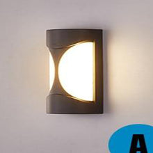 Load image into Gallery viewer, Navojoa Model D cylindrical wall light, warm white illumination on brick exterior
